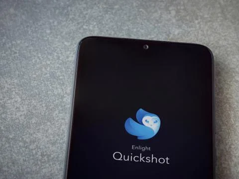 Enlight Quickshot app launch screen with logo on the display of a black mobil Stock Photos