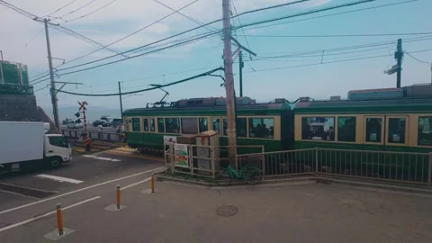 Enoden Electric Train Passing Through Urban Tracks Near Enoshima Stock Footage 346104571