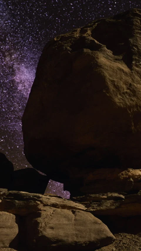 Enormous balanced rock surrounded by celestial galaxy scene perfect for branding Stock Footage 329017908