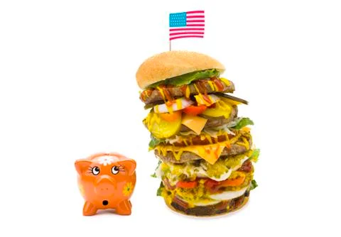 Enormous burger falling over on piggy bank Stock Photos