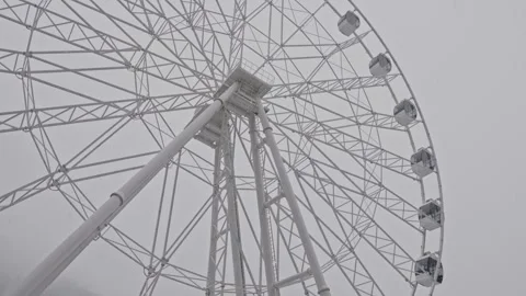 Enormous circular amusement device veiled by fog at seaside front 動画素材 333334315