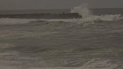 Enormous Ocean Waves Crash Onto Rugged Coastline After a Storm at Sunset Stock Footage 341683941