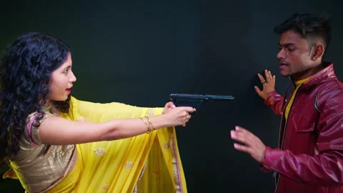 Enraged lady points a weapon at a man Stock Footage 295523835