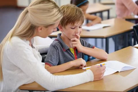 Enriching eager young minds. A young teacher in her classroom. Stock Photos