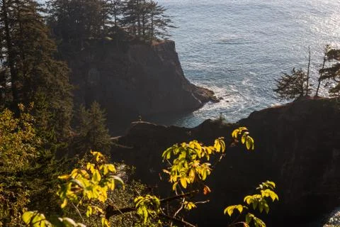 Ensenada at sunset with the tiny figure of a person on the crest of the rock in Stock Photos