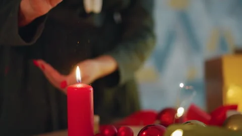 Ensuring flame safety while wrapping presents during festive season. Maintaining Stock Footage 335399593