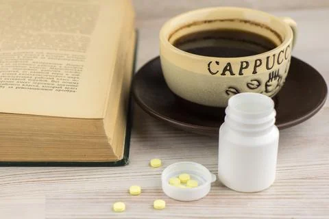 Ensuring good employee: a pack of tablets of ephedrine, Cup of strong coffee  Stock Photos