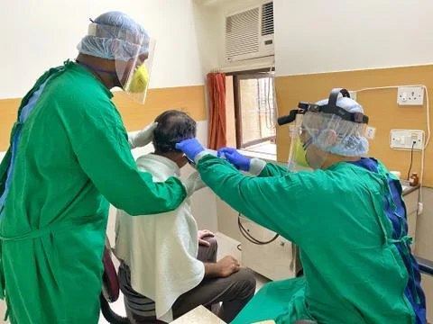 ENT doctors examining in ppe Stock Photos
