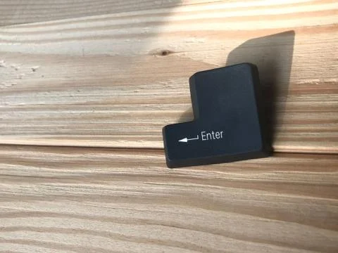The enter black button on rubberwood table in studio with sunlight Stock Photos