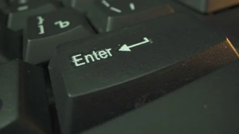 Enter button on the black keyboard in sunset light. Close up shot. Stock Footage 141587925