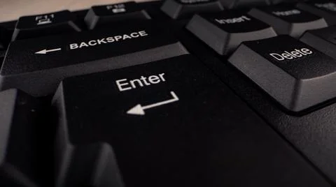 Enter button with letters and arrow sign on black keyboard Stock Photos