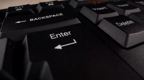 Enter button with letters and arrow sign on black keyboard Stock Photos