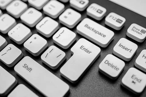 The Enter key and surrounding white keys of a modern computer keyboard. Stock Photos