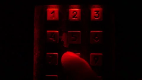 Enter number in the dark, red light. Stock Footage 97925512