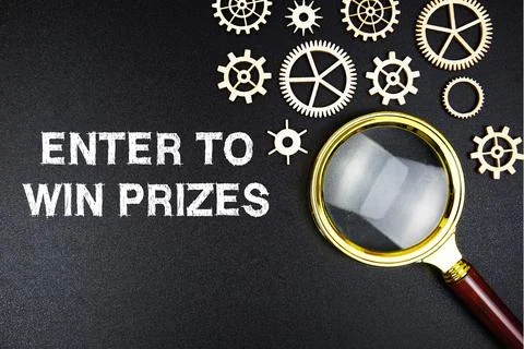 Enter To Win Prized text message with magnifying glass on black background Stock Photos