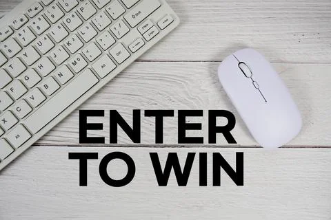 Enter to Win text with keyboard and wireless mouse on wooden background Stock Photos