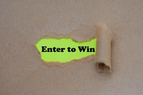Enter to win word written under torn paper Foto stock