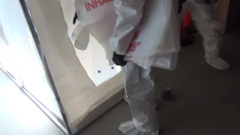 Entering the asbestos enclosure Stock Footage 105389537
