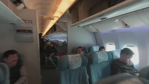 Entering the cabin of the plane and getting ready to take a seat Video stock 145881414