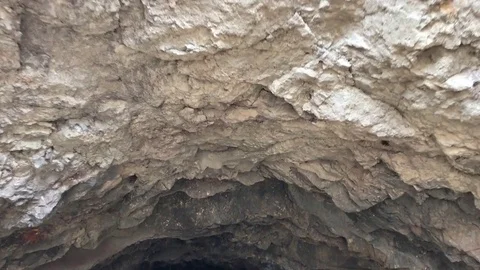 Entering cave top view Vídeos de archivo 76504432
