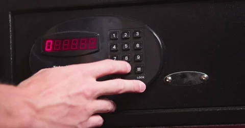 Entering code and removing money from hotel safe Stock Footage 37510192