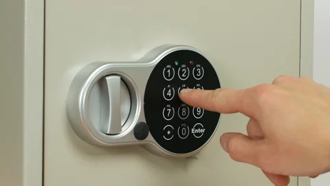 Entering a combination of numbers to open a safe and place valuable items there. Stock Footage 88602578