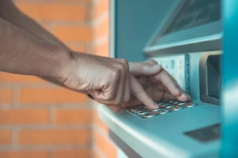 Entering a credit card code on the ATM keyboard 스톡 사진