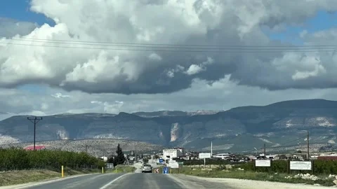 Entering Karaman region via highway   with dramatic mountain backdrop Stock Footage 305910492