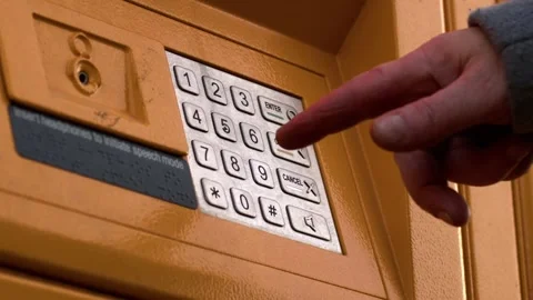 Entering key code in collection locker Stock Footage 228850790