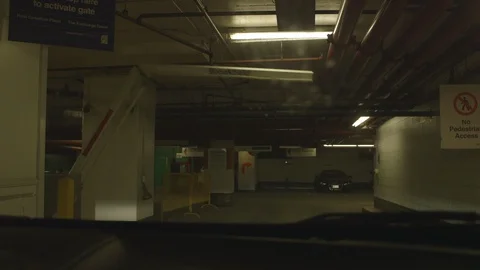 Entering a Parking Garage as Gate Opens Stock Footage 115861670