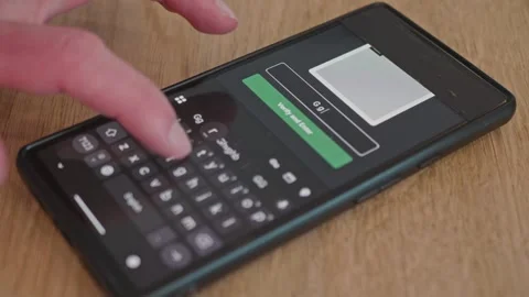 Entering a password on a smartphone screen to gain access Stock Footage 337998816