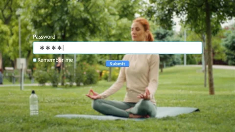 Entering password on a website while a woman practices yoga in the park Stock Footage 346710184