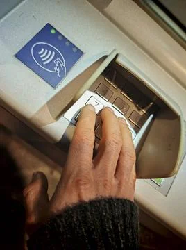  entering the pin code at an ATM or cash machine entering pin code at an A... Foto stock