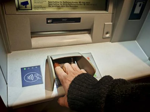 Entering pin code at an ATM Photos