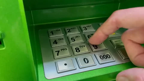 Entering pin code numbers on a ATM keyboard. Withdrawing money from an ATM Stock Footage 170919157