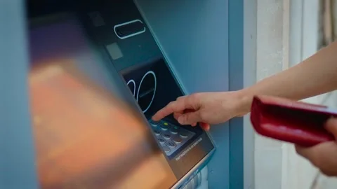 Entering PIN code on outdoor ATM keypad during banking transaction and cash Stock Footage 336108617