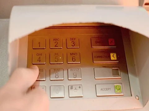 Entering a PIN number into a ATM machine Stock Footage 77338355