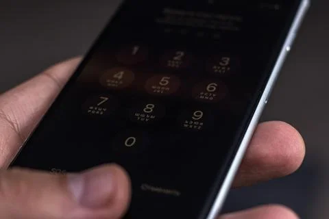 Entering a pin or secret code on a smartphone. The screen with the numbers of Stock Photos