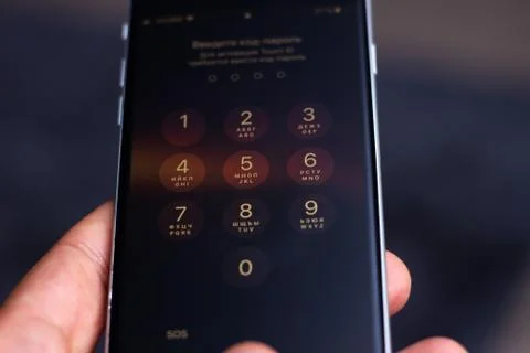 Entering a pin or secret code on a smartphone. The screen with the numbers of Stock Photos