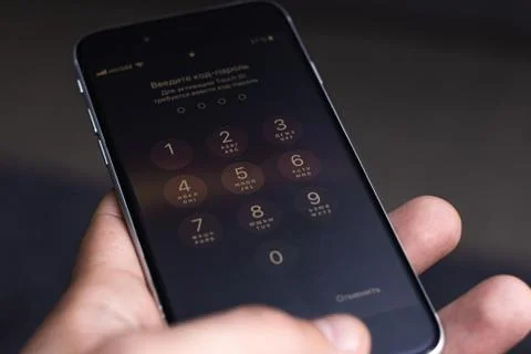 Entering a pin or secret code on a smartphone. The screen with the numbers of Stock Photos