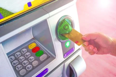 Entering press button number code on machine to withdraw. Stock Photos