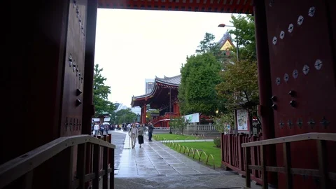 Entering Side Gate to Senso Ji Temple Grounds in Asakusa district of Tokyo, Stock Footage 98294747