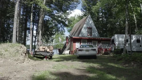 Entering Triangle-shaped Cabin Waterfront Property Maine Drone Footage DLOG Stock Footage 138171763