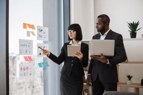 Enterpreneurs working on data with modern devices in office 스톡 사진