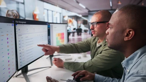 Enterprise Risk Managers Analyze Financial Data On Computer Stock Footage 336369379