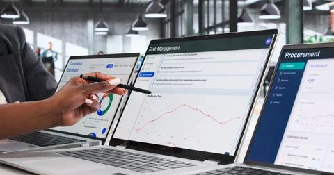Enterprise Risk Managers Collaborate On Strategic Data Analysis Using Laptop. Stock Photos