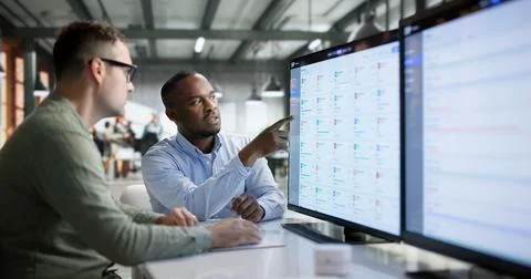 Enterprise Software Developer Discusses Cloud ERP Interface With Team Members Stock Photos