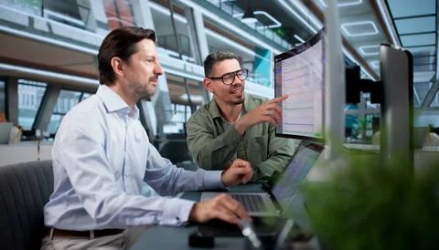 Enterprise Software Manager Carefully Evaluates Cloud ERP System Using Wide C Stock Photos