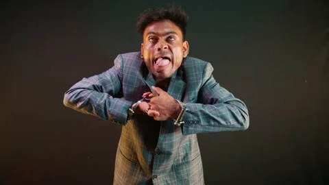 Entertainer makes faces while removing metal cuff Video stock 313669322