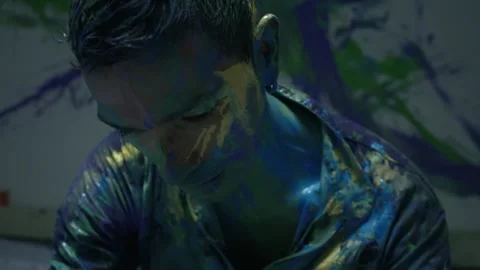 Entertaining art of a man dancing bathed in colored paint Stock Footage 255599722
